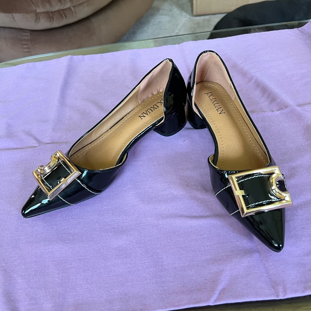 Never worn!!! Gorgeous Black patent leather with gold buckle and red bottom.